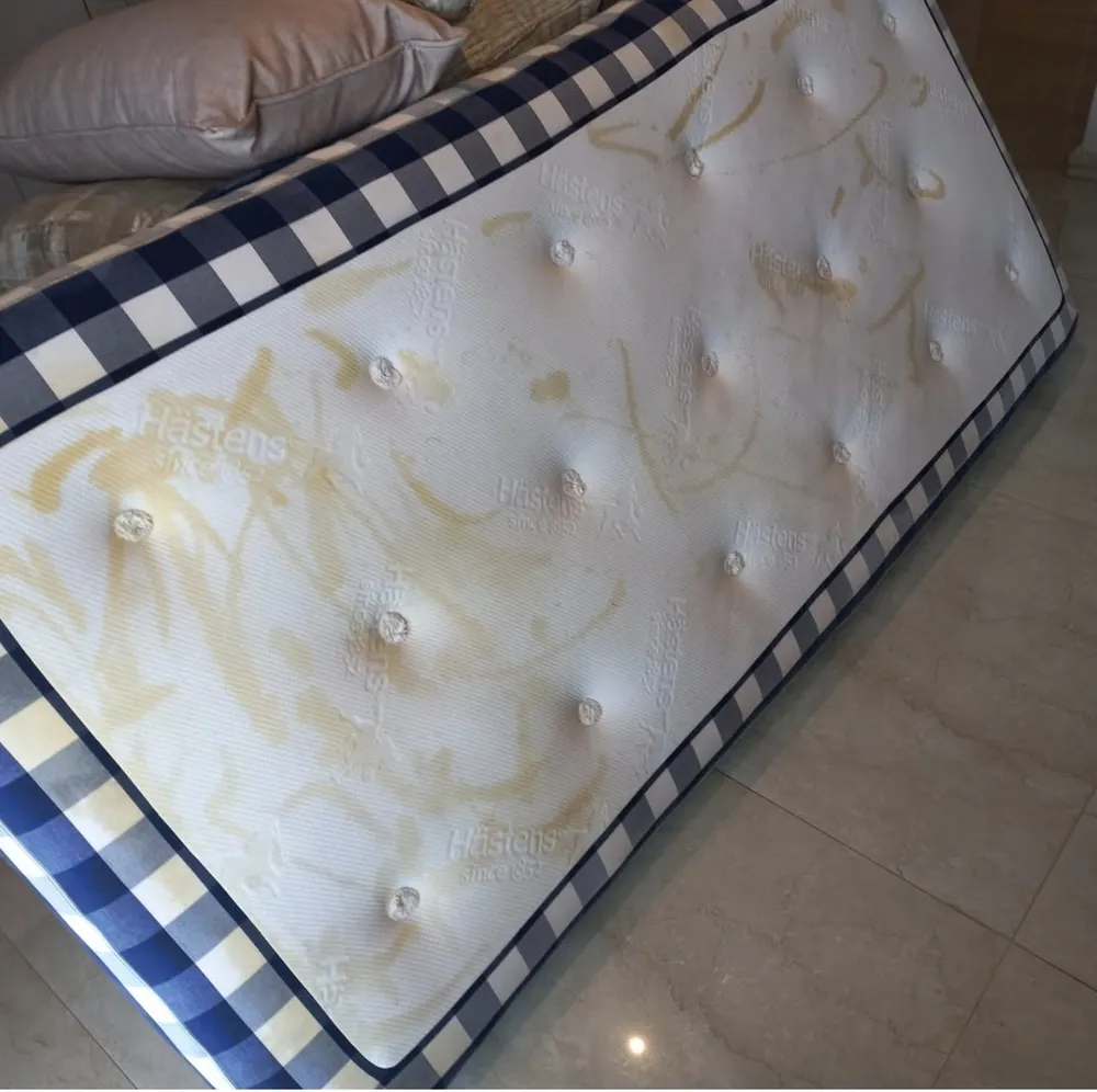 Mattress before cleaning, with heavy yellow stains