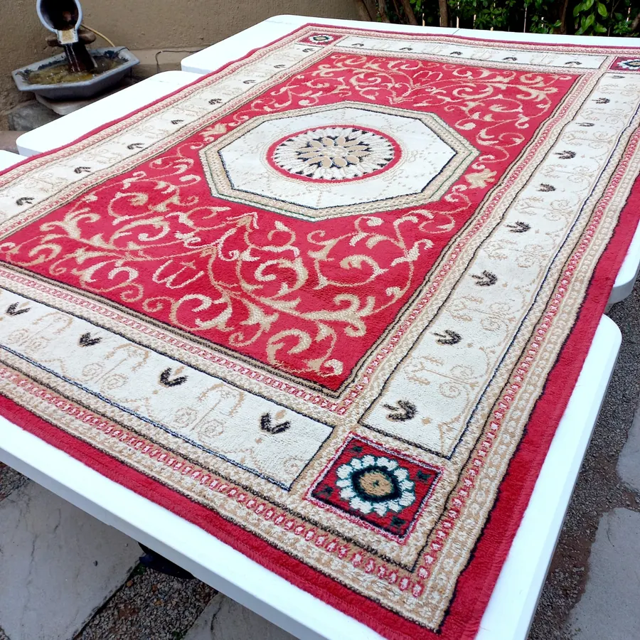 Persian-style rug before cleaning, dull and dusty